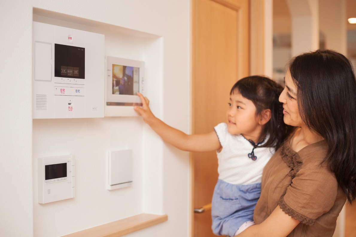 Mother and daughter looking at smart home screen